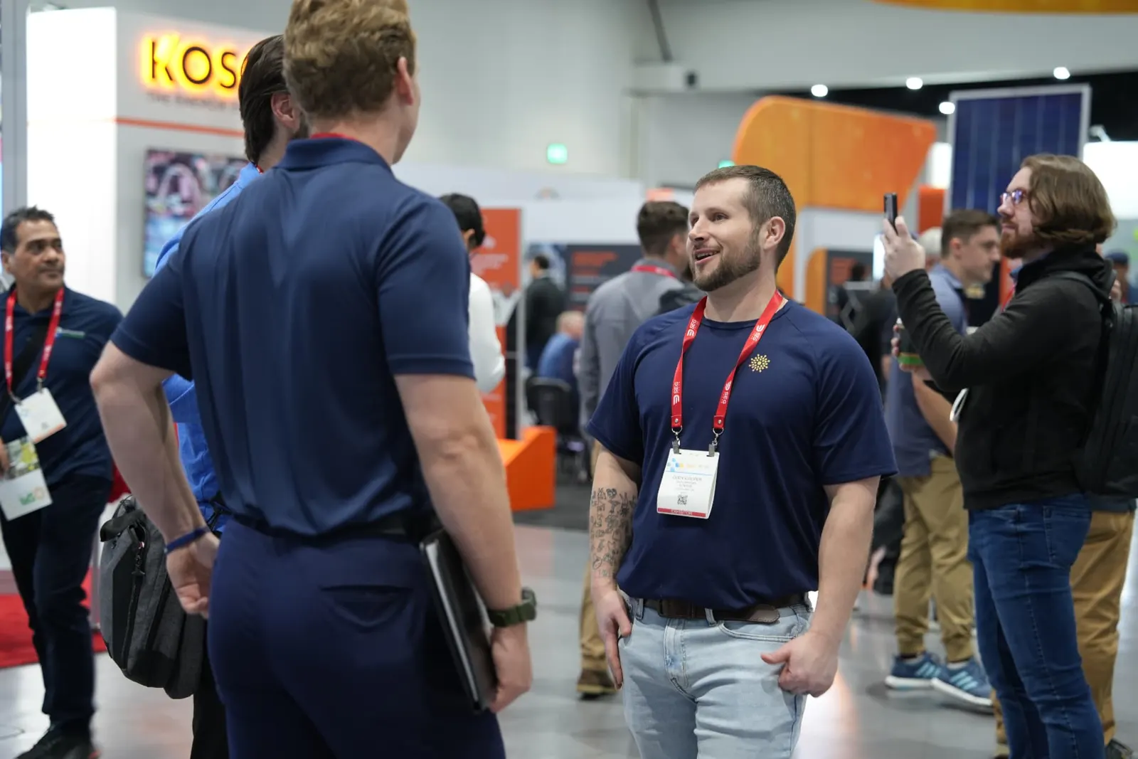 Cody Cooper talking with installers on the Intersolar show floor