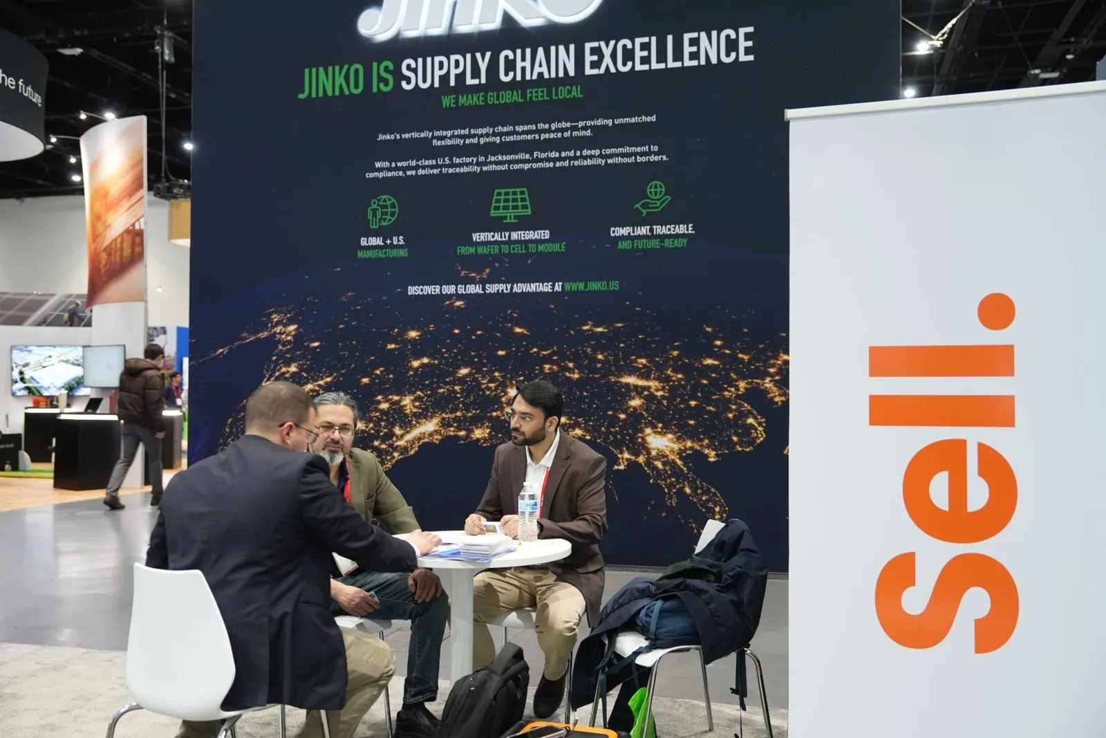 Sunhub team meeting buyers at a table on the show floor