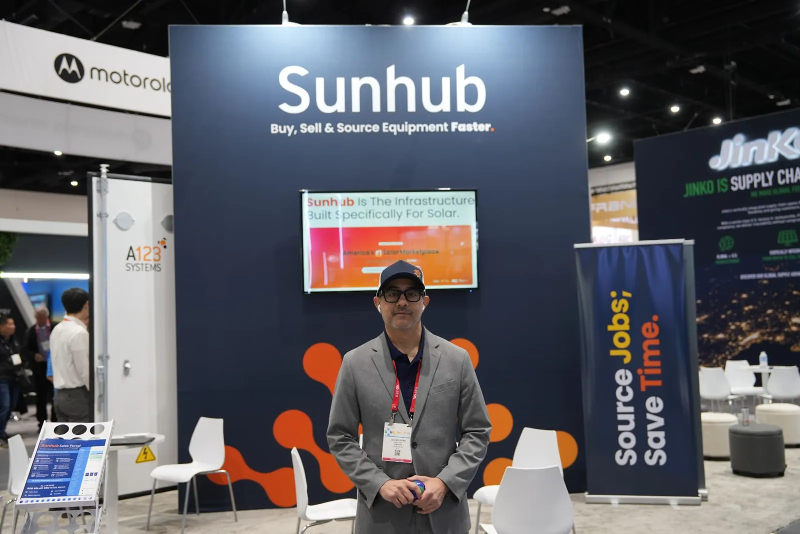 Azam Kazmi in front of the Sunhub booth display at Intersolar