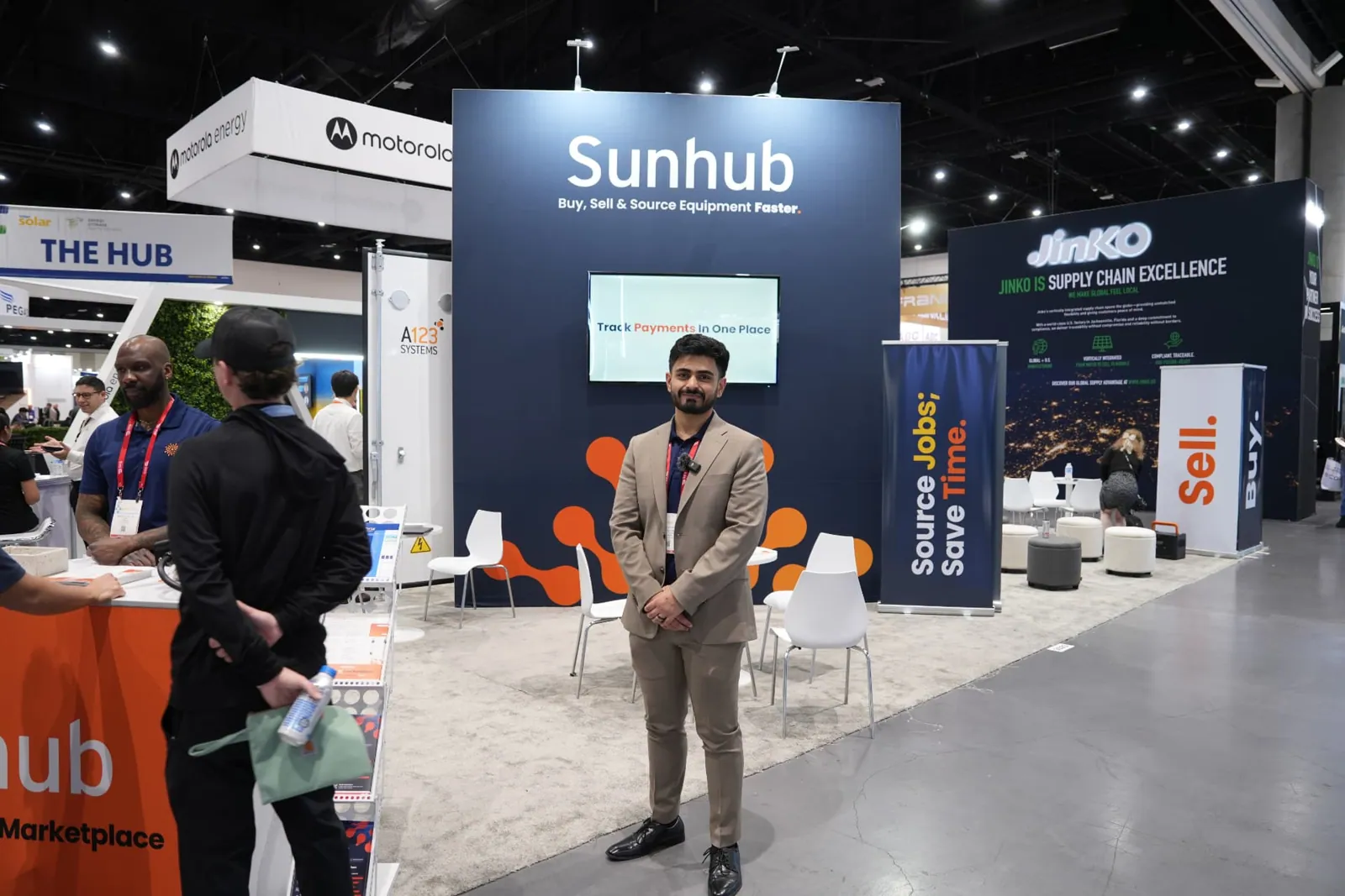 Sunhub team member in front of the Sunhub booth wall at Intersolar
