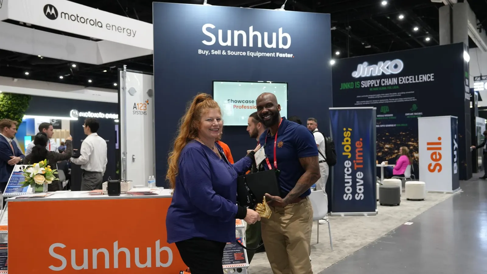 Visitor collecting a Sunhub tote at the booth